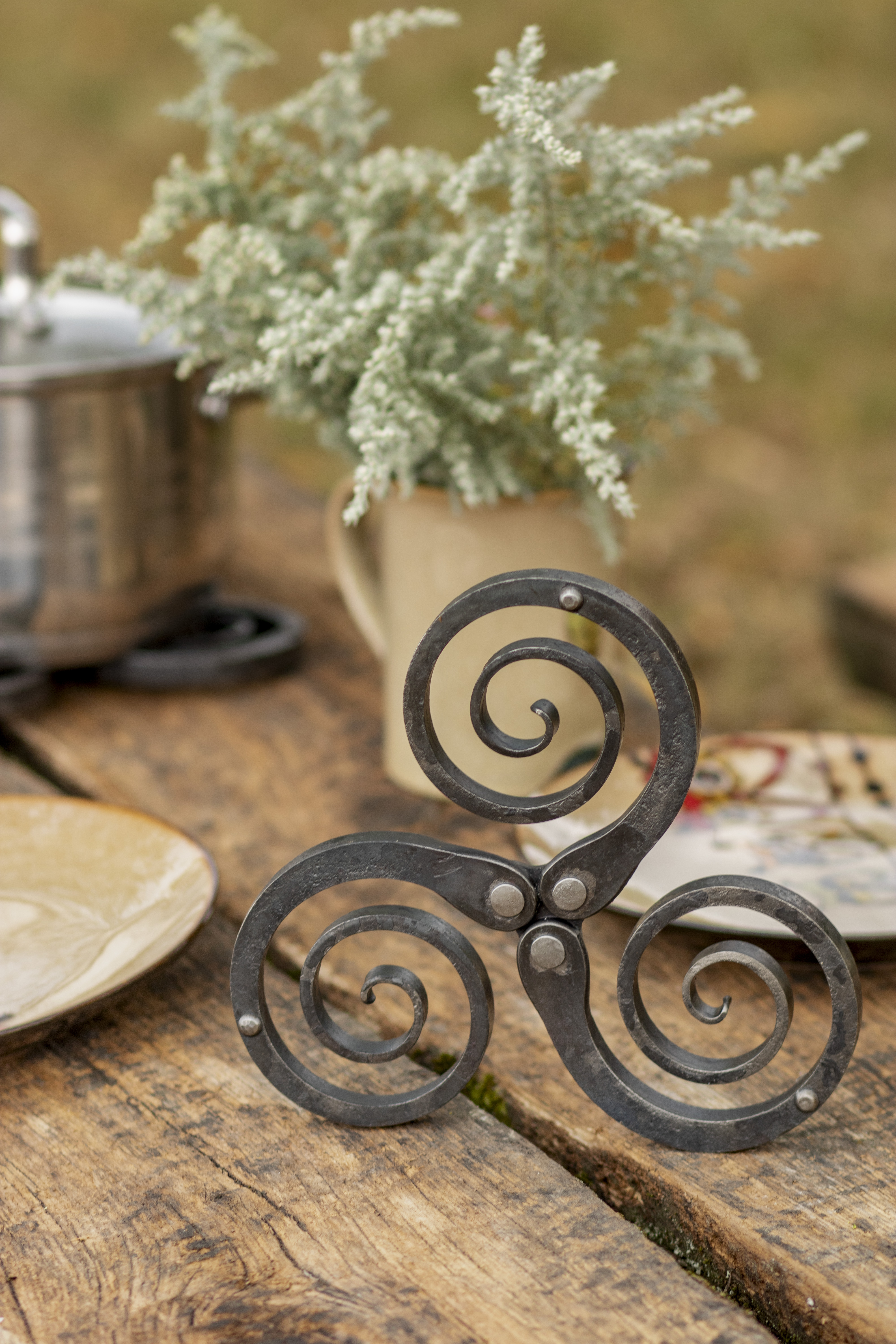 Rustic wrought iron trivet - hand forged metal pot holder and table decor featuring a Celtic triskelion design, photo 2
