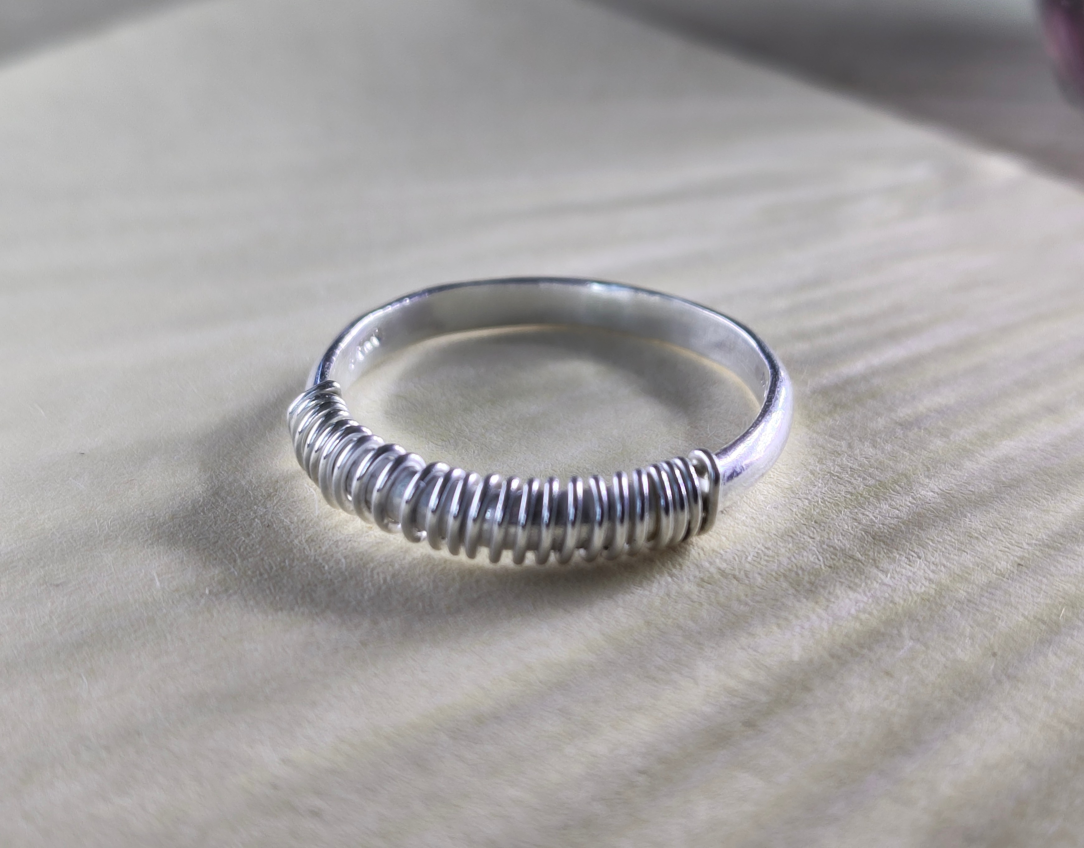 Sterling silver ring band, hand-wrapped in a coil of silver wire