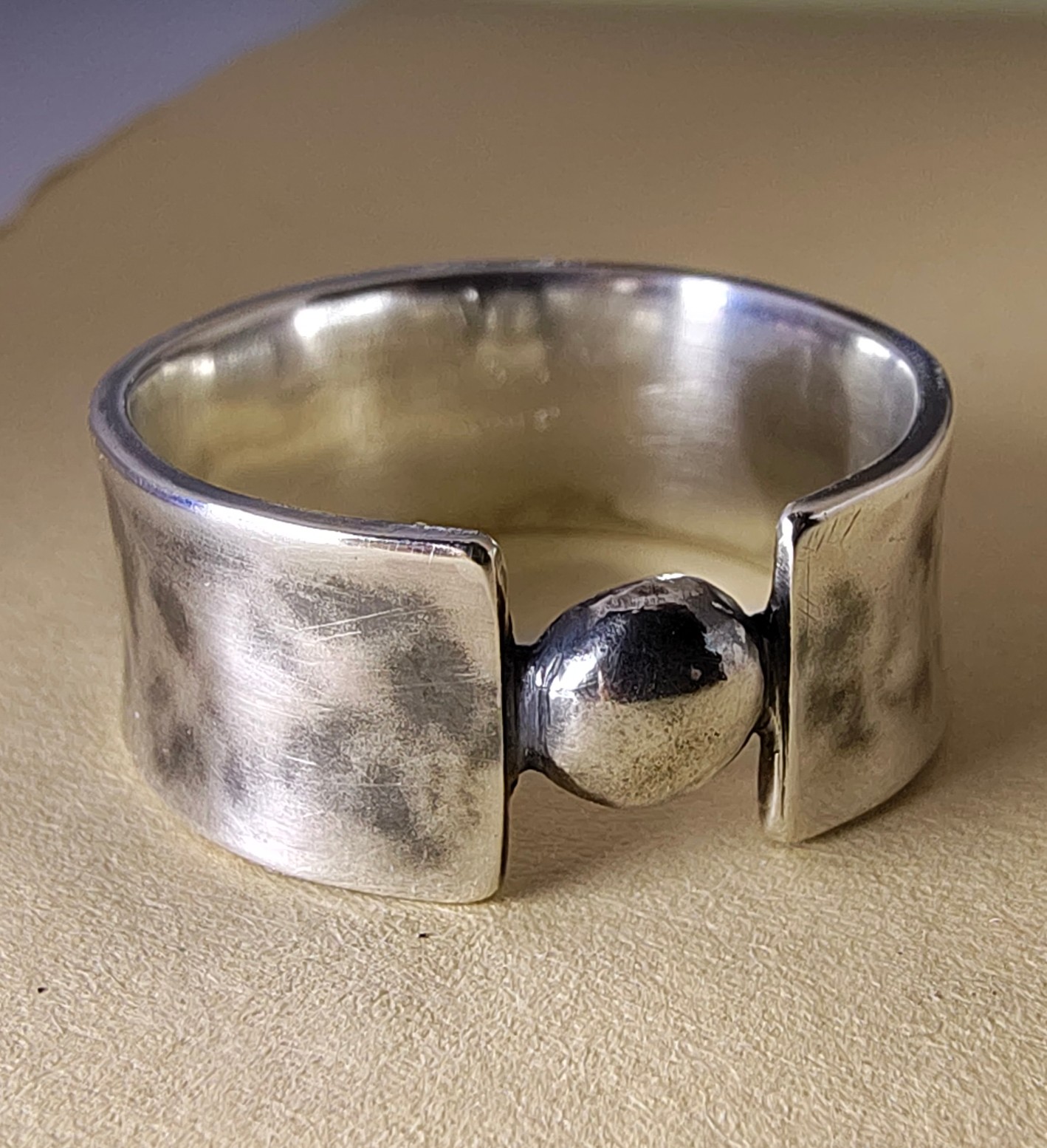 Hand-hammered sterling silver ring with patina and a single sphere set in the opening, photo 6