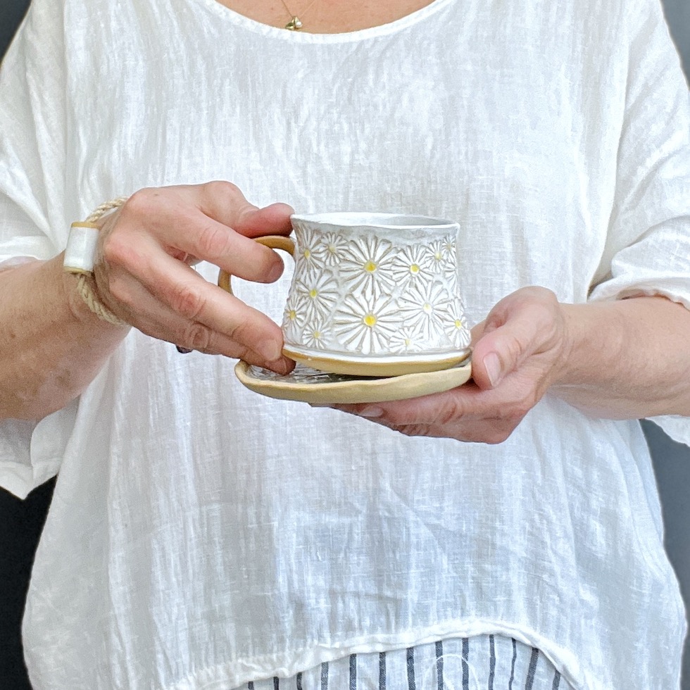 White teacup with saucer daisy meadow motif