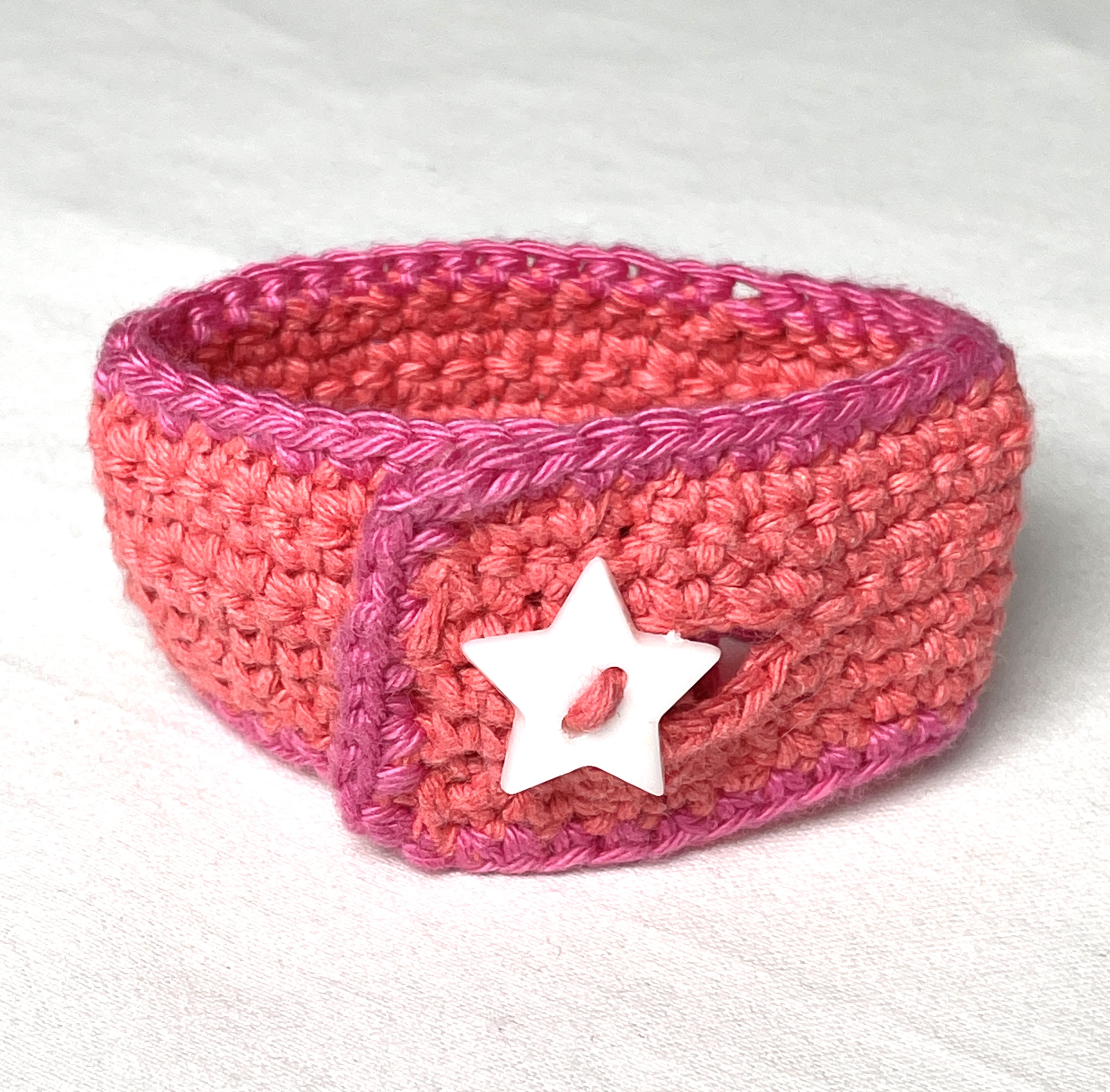 Crochet wristband, coral and pink