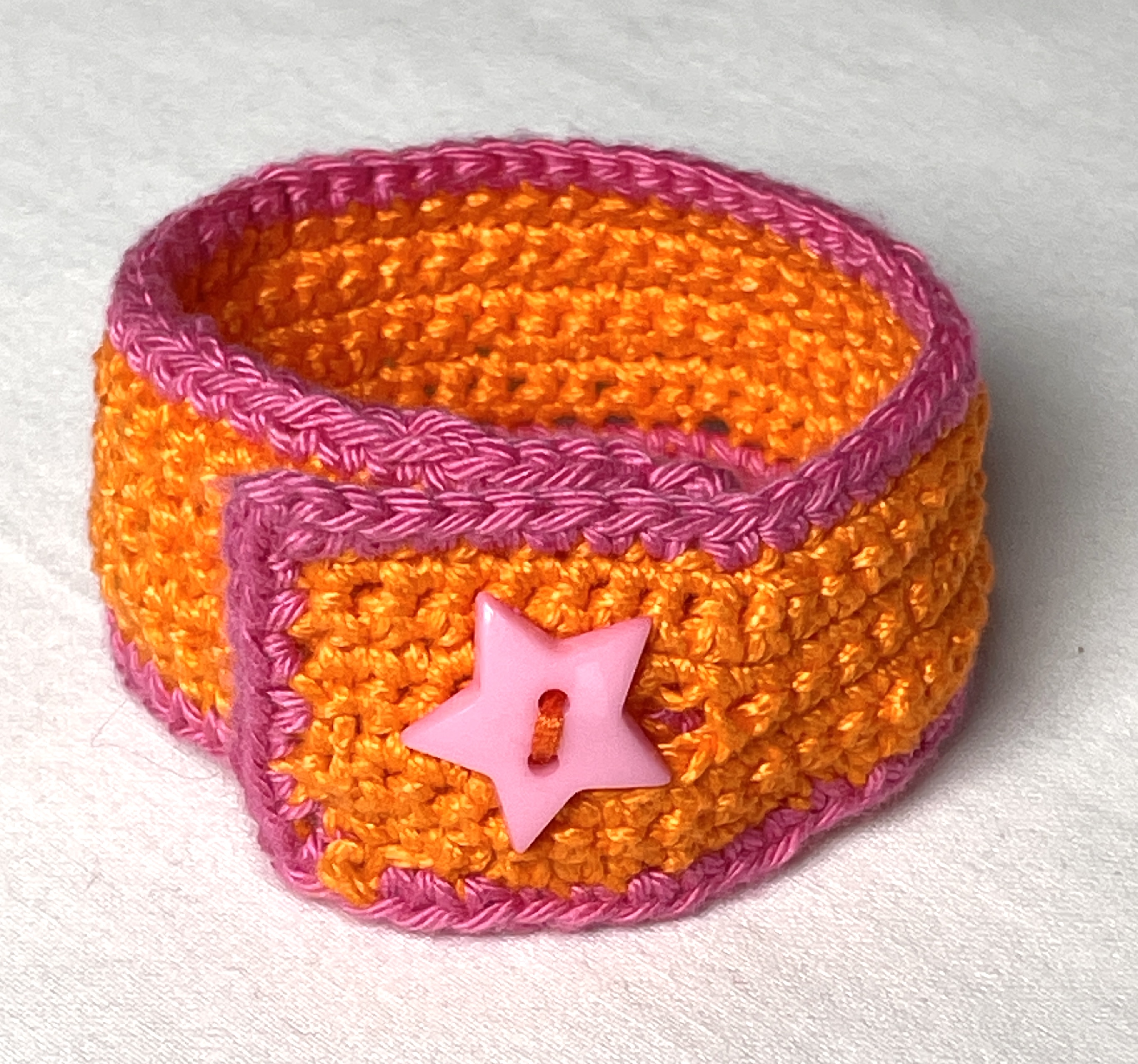 Crochet wristband, orange and pink
