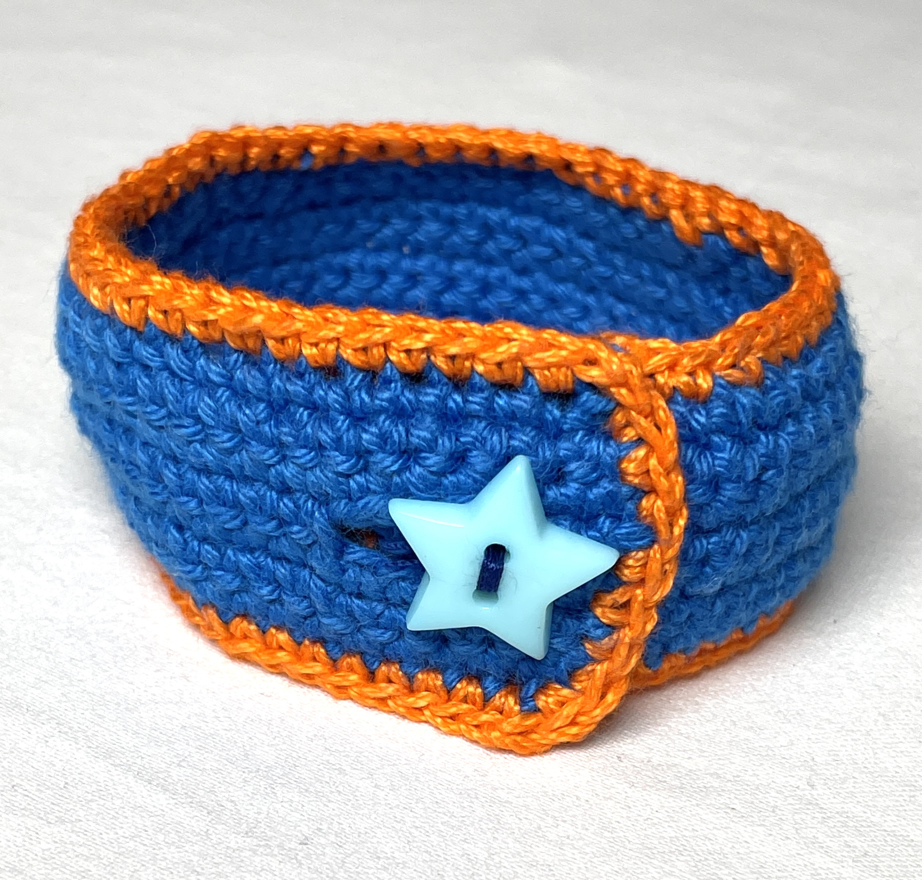 Crochet wristband, blue and orange